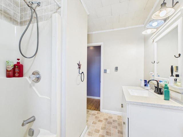 bathroom featuring vanity, baseboards, and ornamental molding