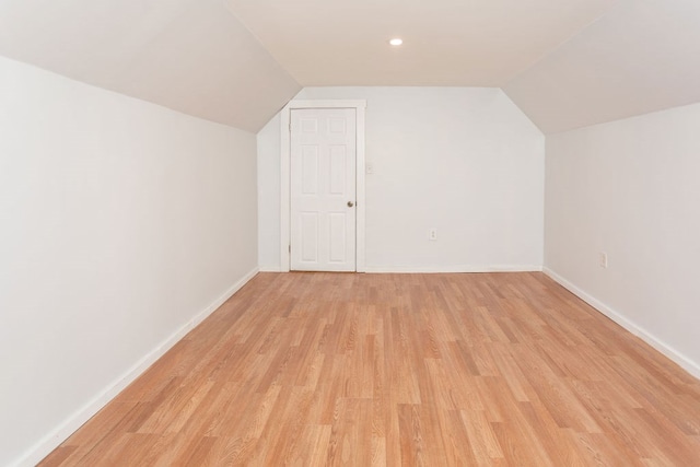 bonus room with light hardwood / wood-style floors and lofted ceiling