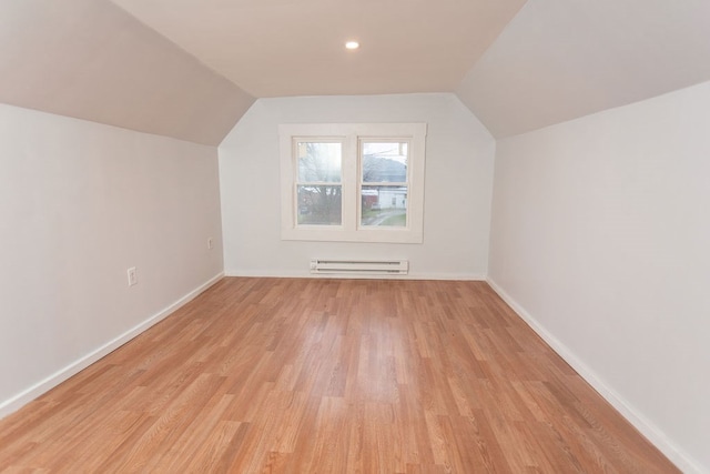 bonus room with a baseboard radiator, lofted ceiling, and light hardwood / wood-style floors