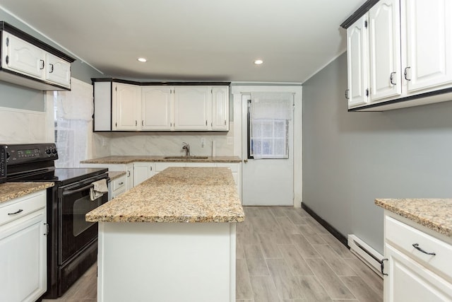 kitchen with white cabinets, a center island, sink, and black range with electric cooktop