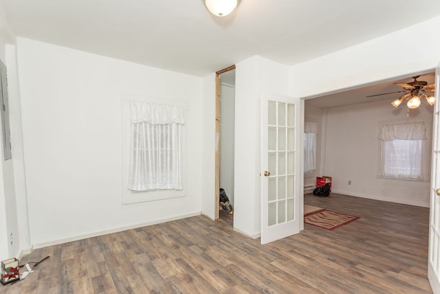 spare room with ceiling fan, dark hardwood / wood-style flooring, and french doors