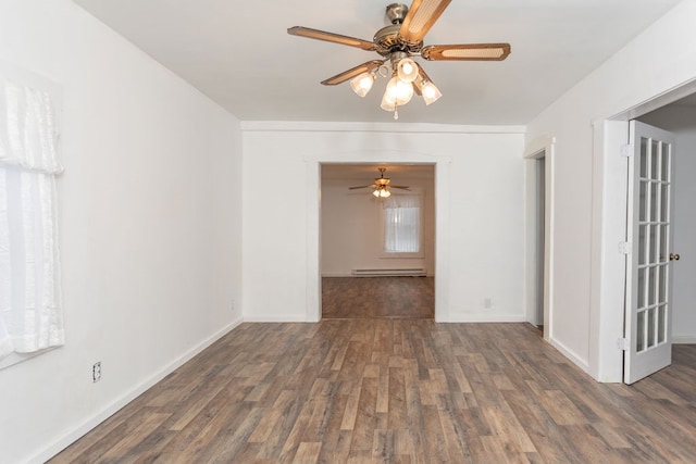 empty room with dark hardwood / wood-style floors, ceiling fan, and baseboard heating