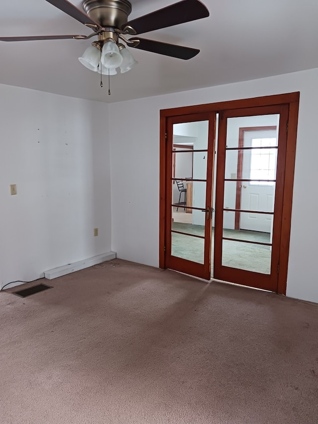 unfurnished room featuring french doors, ceiling fan, and carpet flooring