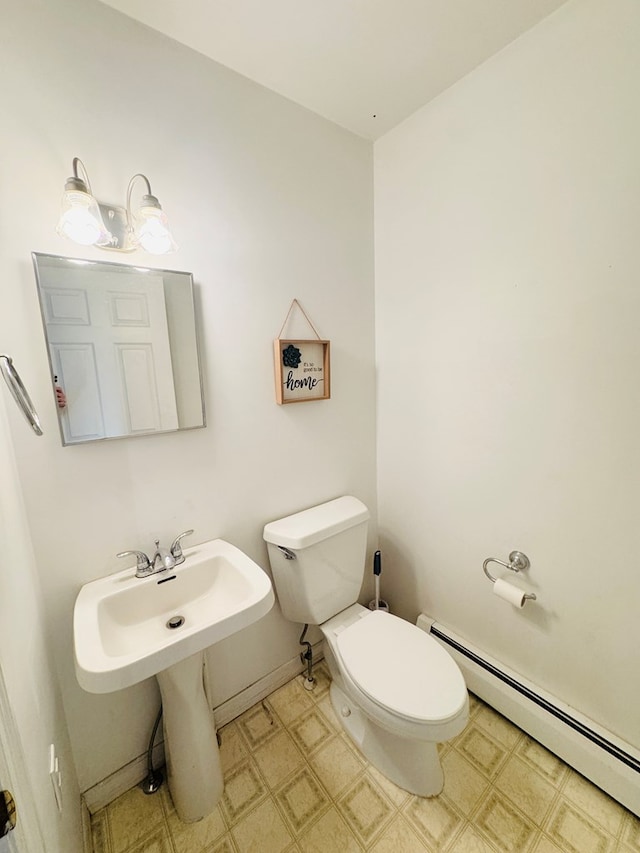 bathroom featuring toilet and a baseboard heating unit