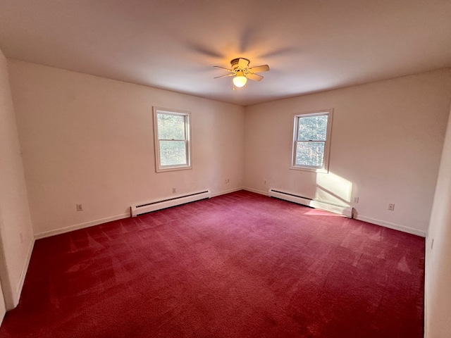 empty room with carpet floors, a baseboard radiator, and a wealth of natural light