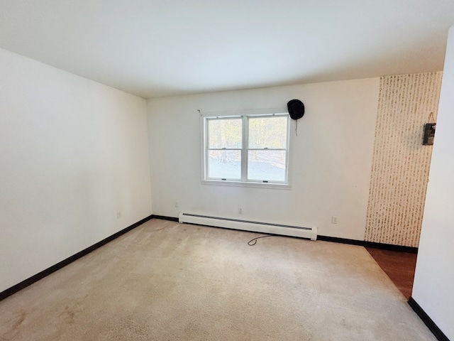 carpeted spare room with a baseboard radiator