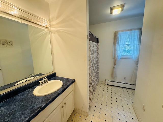 bathroom with a baseboard heating unit and vanity