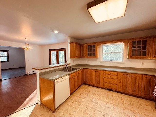 kitchen featuring dishwasher, a baseboard radiator, sink, decorative light fixtures, and kitchen peninsula