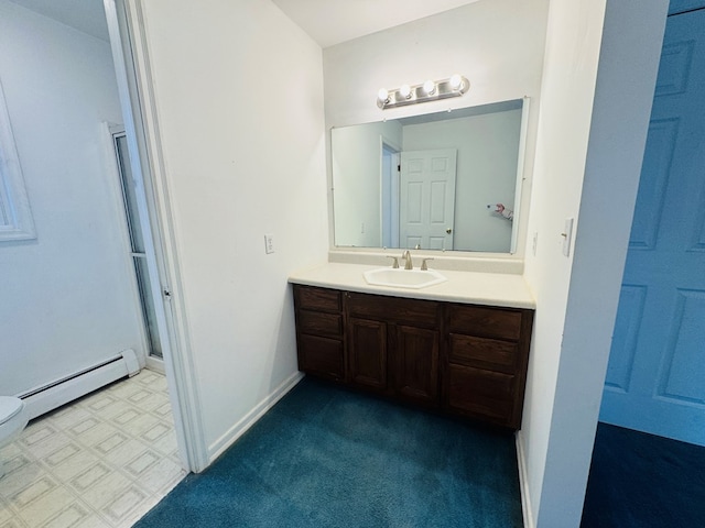 bathroom with a baseboard heating unit and vanity