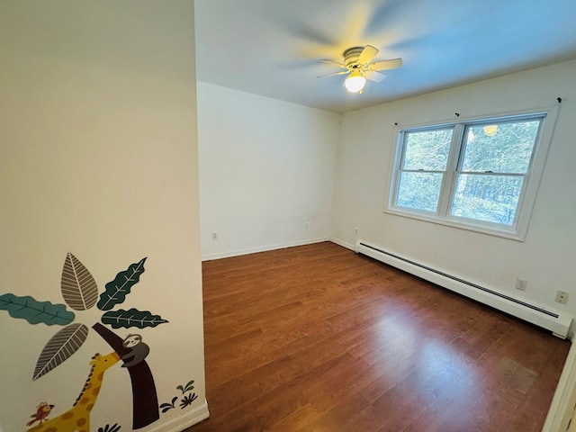 empty room featuring ceiling fan, hardwood / wood-style floors, and baseboard heating