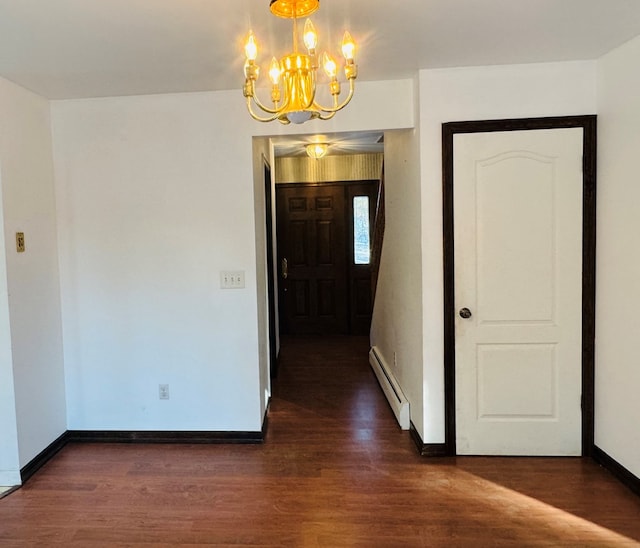 interior space featuring dark hardwood / wood-style floors, an inviting chandelier, and a baseboard radiator