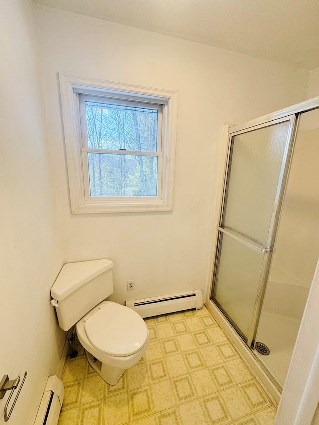 bathroom featuring a shower with door, toilet, and a baseboard heating unit