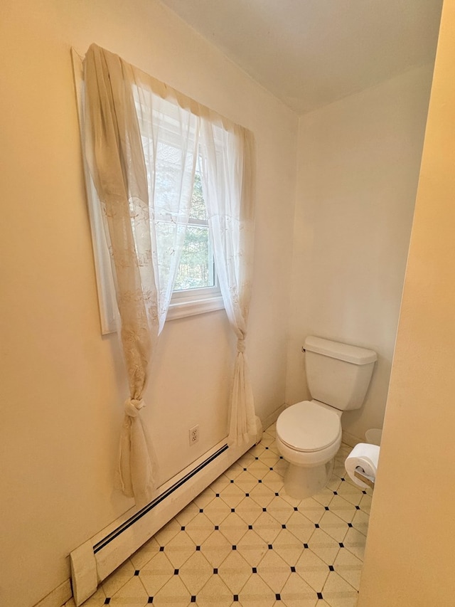 bathroom with toilet and baseboard heating