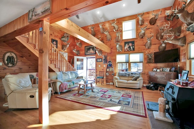 5284-A Rte 6 W, Ulysses, PA 16948 - living room with stairway, wood walls, a wood stove, wood finished floors, and a high ceiling