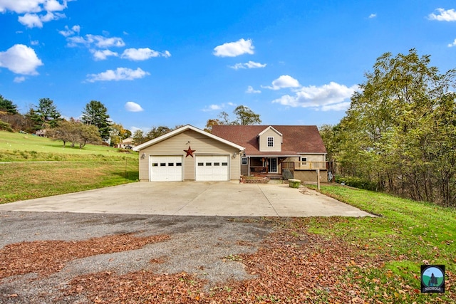 view of front of property featuring a front lawn, covered porch, and a garage