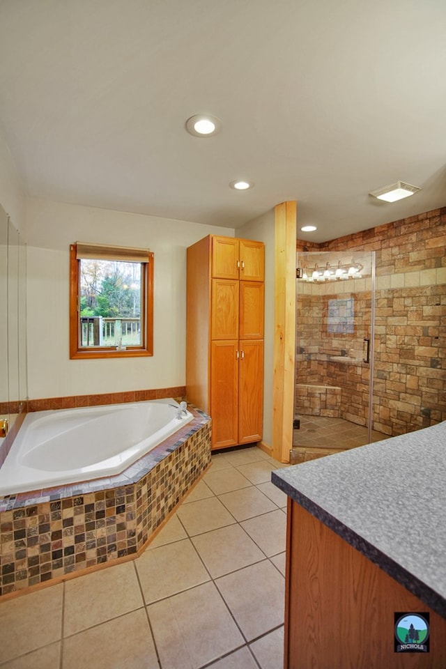 bathroom with tile patterned flooring, shower with separate bathtub, and vanity