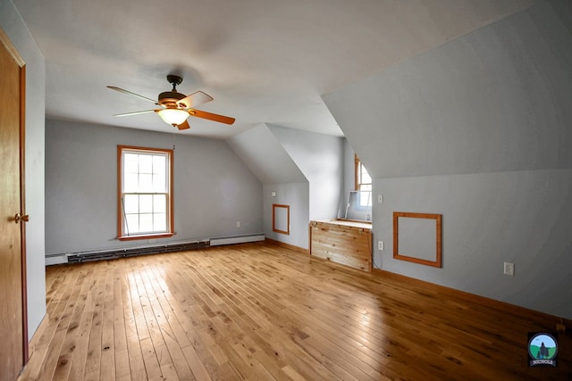 bonus room featuring ceiling fan, light wood-type flooring, baseboard heating, and vaulted ceiling