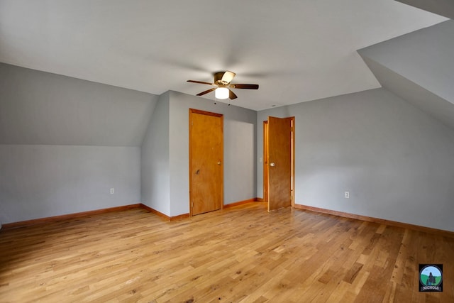 additional living space with ceiling fan, vaulted ceiling, and light wood-type flooring