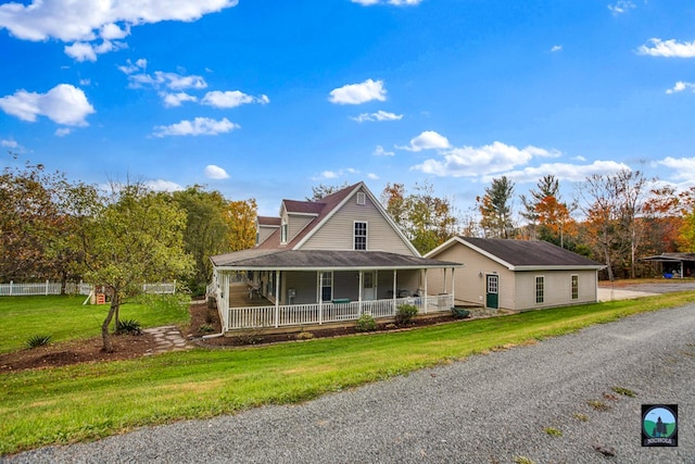 farmhouse featuring a front lawn and covered porch