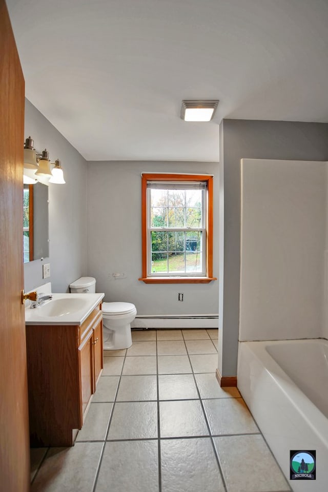 bathroom with toilet, vanity, a baseboard radiator, and tile patterned floors