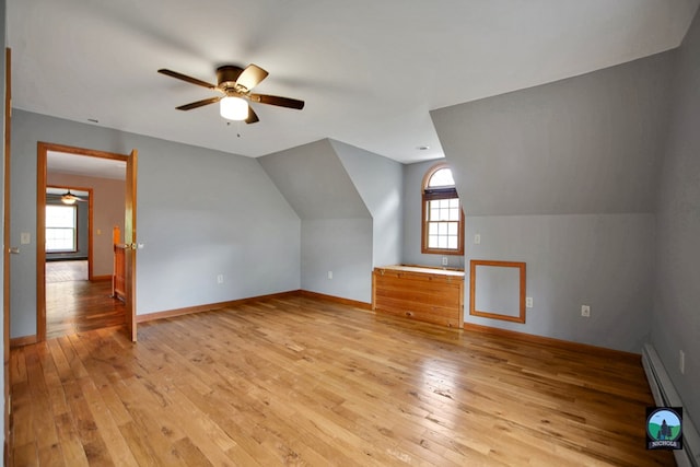 bonus room with vaulted ceiling, light hardwood / wood-style flooring, and a wealth of natural light