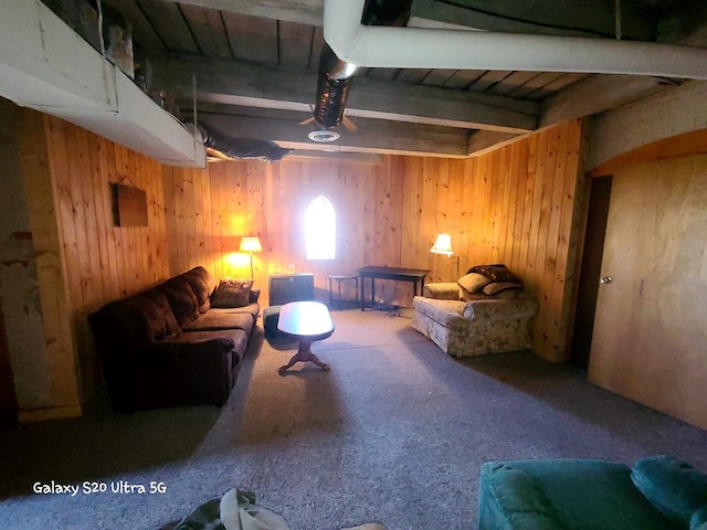 living room featuring wooden walls and carpet