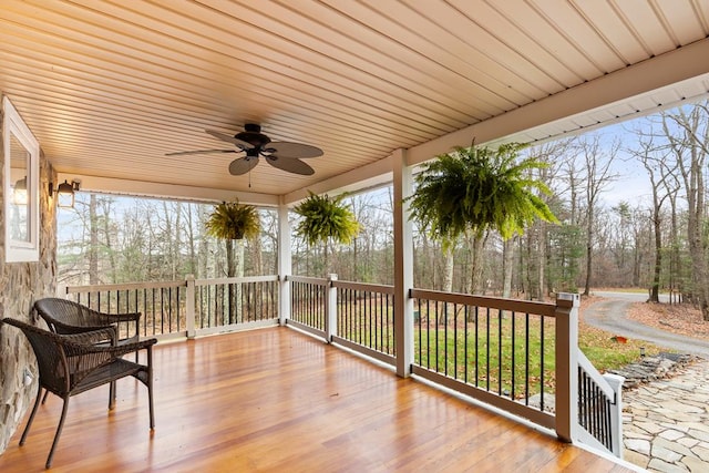 wooden deck with a porch and ceiling fan