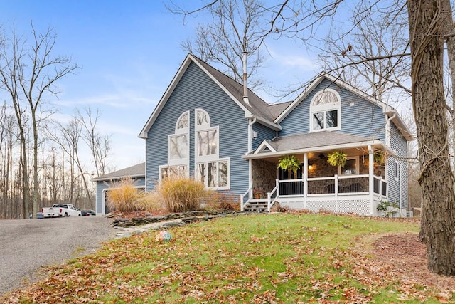 view of front of home with a porch and a front lawn