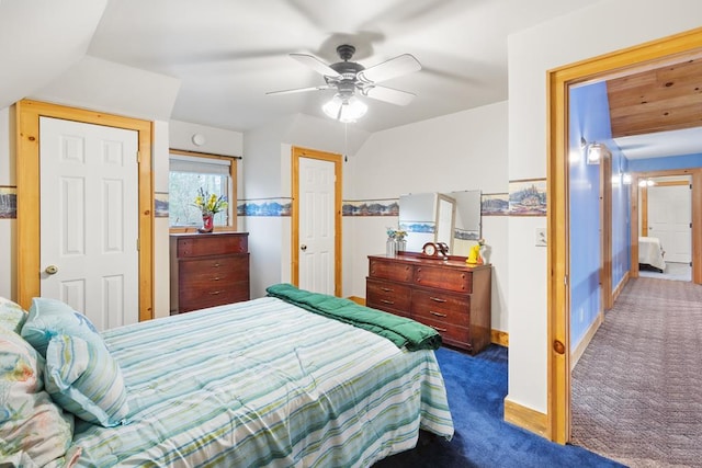 carpeted bedroom with vaulted ceiling and ceiling fan