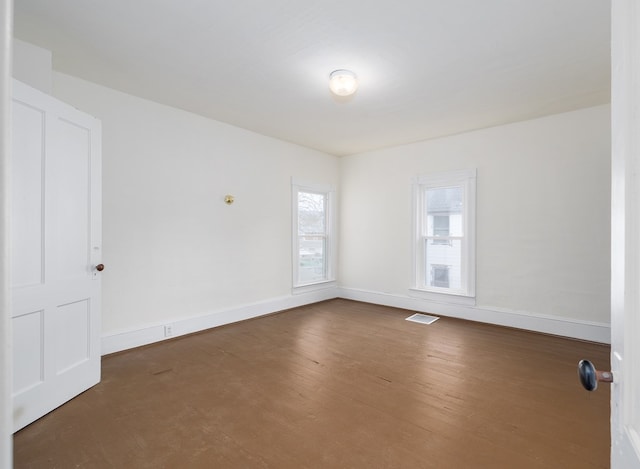 empty room with dark wood-type flooring