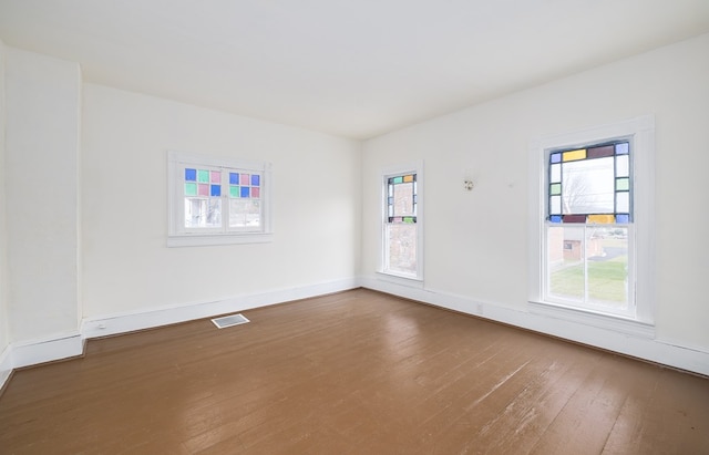 empty room with hardwood / wood-style flooring