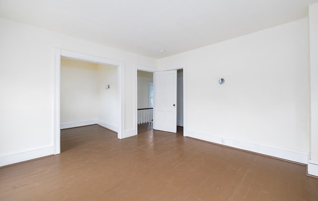 empty room with hardwood / wood-style flooring