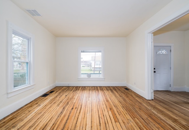 spare room featuring light wood-type flooring