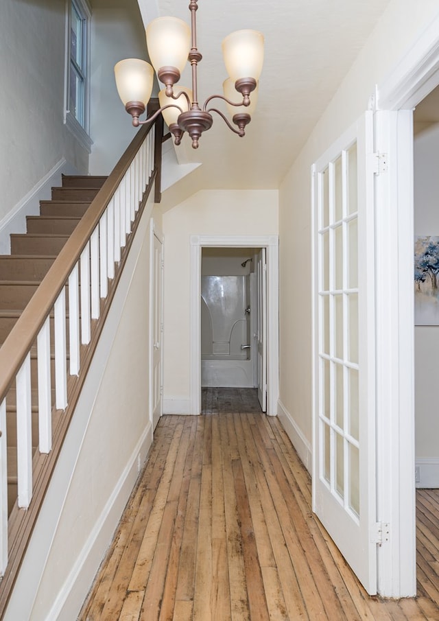 entrance foyer featuring light hardwood / wood-style floors and an inviting chandelier