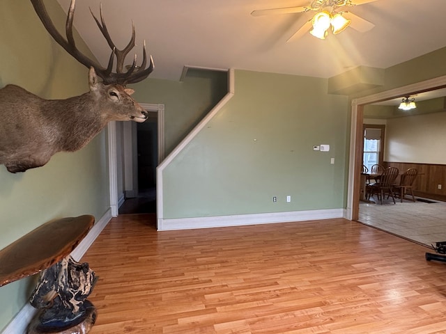 unfurnished living room with ceiling fan and light hardwood / wood-style floors