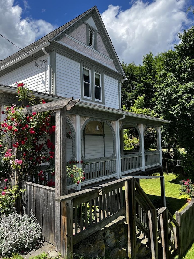 view of front of house with a front yard and a porch