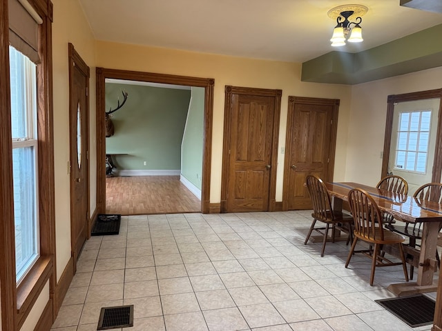 dining room featuring light tile patterned floors, a chandelier, and a wealth of natural light