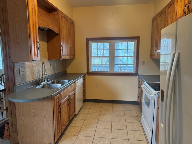 kitchen with backsplash, sink, white appliances, and light tile patterned floors