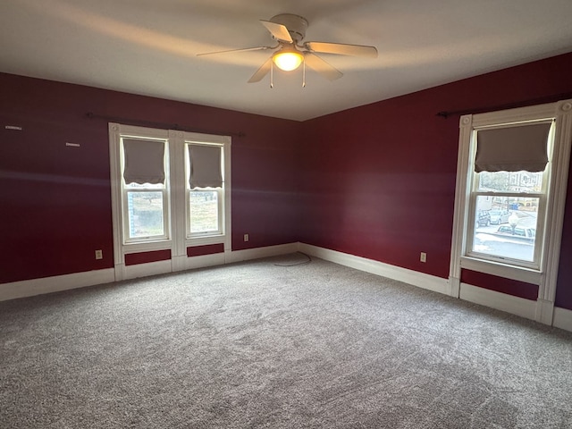 spare room featuring ceiling fan and carpet flooring