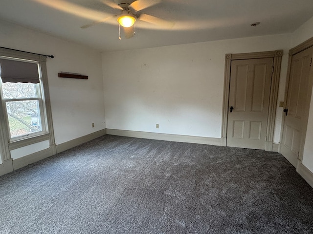 carpeted spare room with ceiling fan