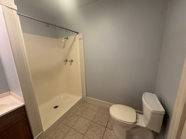 bathroom featuring a shower, toilet, vanity, and tile patterned flooring