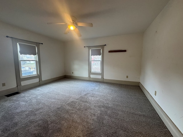 unfurnished room featuring ceiling fan and carpet