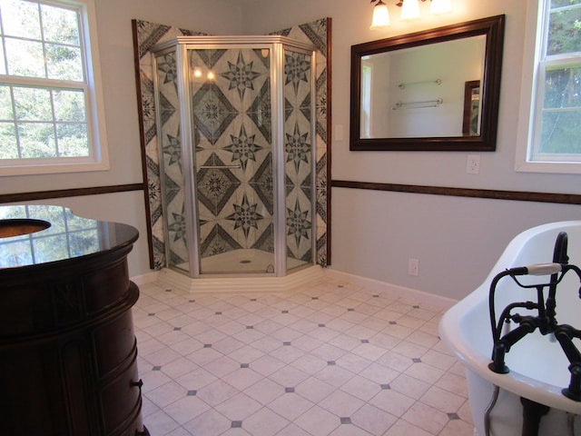 bathroom featuring tile patterned flooring, vanity, and walk in shower