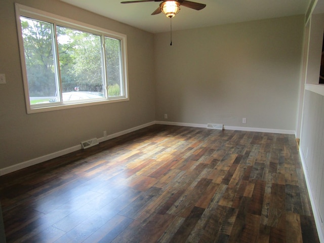 spare room featuring ceiling fan and dark hardwood / wood-style floors