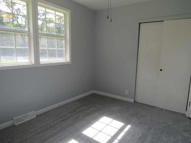 unfurnished bedroom with carpet floors and a closet