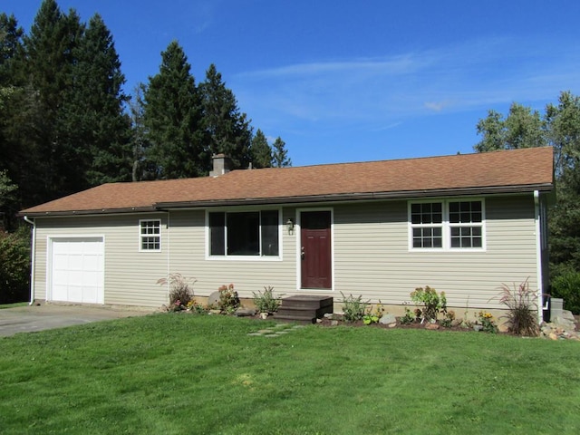 ranch-style house featuring a garage and a front lawn