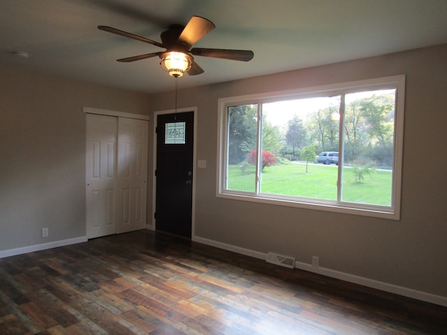 interior space featuring ceiling fan and dark wood-type flooring