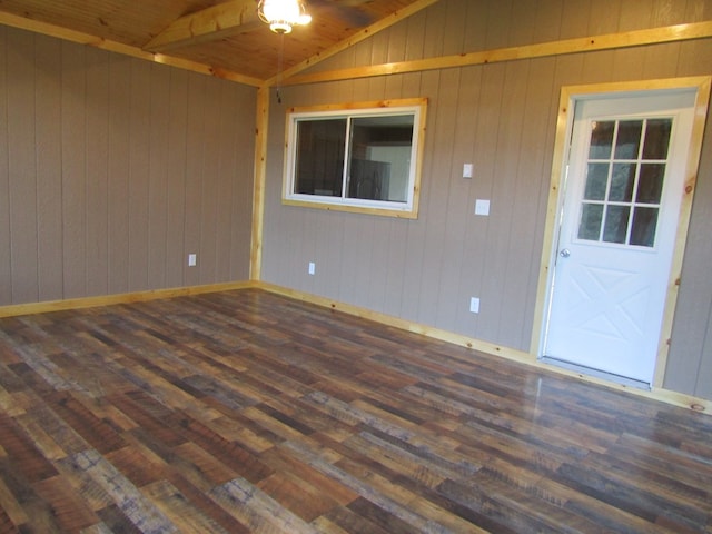 unfurnished room featuring wood walls, dark hardwood / wood-style flooring, lofted ceiling, and wood ceiling