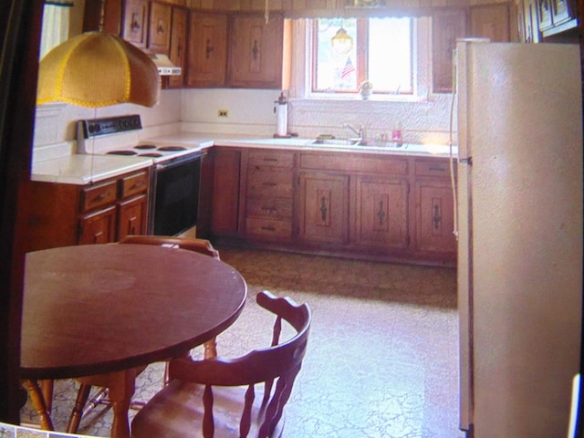 208 Tyler St, Athens, PA 18810 - kitchen with white appliances, a sink, range hood, and brown cabinetry
