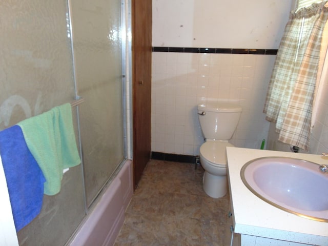 208 Tyler St, Athens, PA 18810 - bathroom featuring toilet, tile walls, vanity, and bath / shower combo with glass door